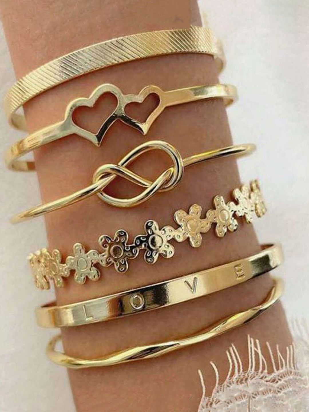 Stackable gold bangle set non‑tarnish cuff bracelets.